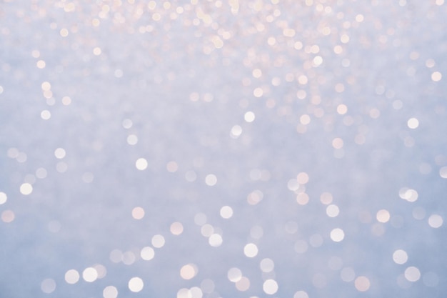 Festive Blue background of silver glitter lights Winter snowy blurred abstraction