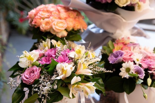 A festive bouquet of roses and other summer flowers in sun light. Flower background