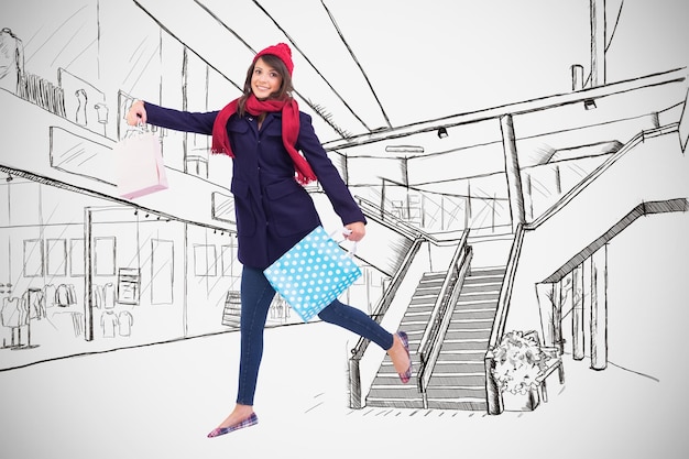 Photo festive brunette holding shopping bags against white background with vignette