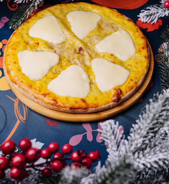 Festive cheese pizza under christmas tree