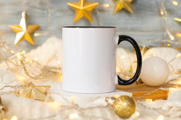 Festive christmas background white ceramic tea mug with black handle and copy space for your imprint