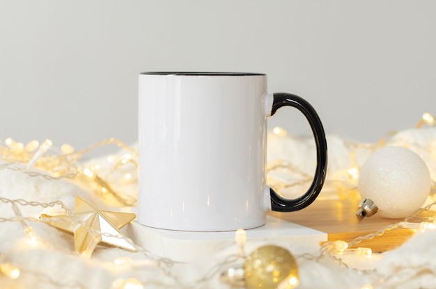 Festive christmas background white ceramic tea mug with black handle and copy space for your imprint