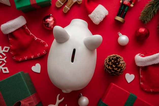 Photo festive christmas financial savings concept white piggy bank money box with presents and decorations