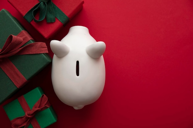 Photo festive christmas financial savings concept white piggy bank money box with presents