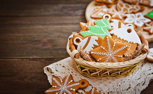 Festive Christmas gingerbread cookies shape  a star lie on a wooden dark brown background.