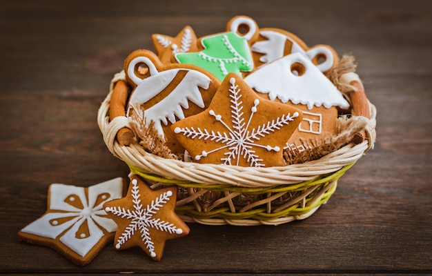 Festive Christmas gingerbread cookies shape  a star lie on a wooden dark brown background.