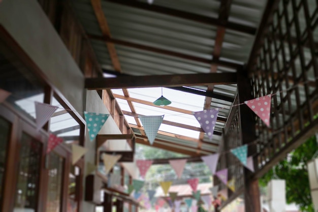 Festive colorful flags decorated on wooden architecture