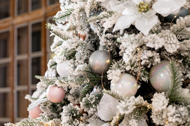 Festive decor.Christmas decorations on the snowcovered branches of an artificial Christmas tree