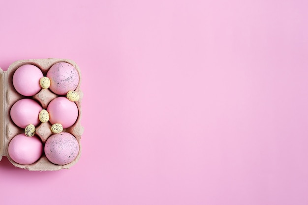 Festive Easter of paper box of handmade pink painted eggs on pink