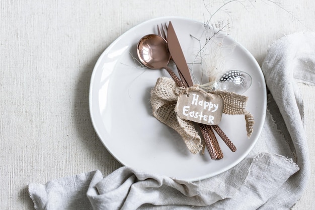 Festive easter table setting with decor details on white table