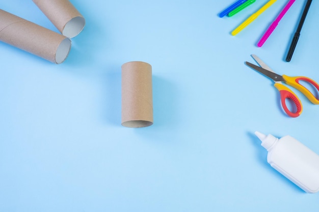 Festive easy DIY craft for children Roll of toilet paper toy bear on a blue background Creative