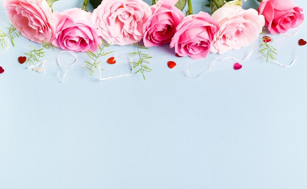 Festive flower composition on blue background Overhead view