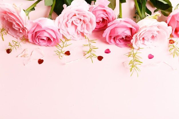 Festive flower composition on pink background Overhead view