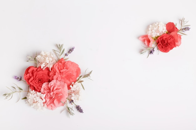 Festive flower composition on the white wooden background Overhead view