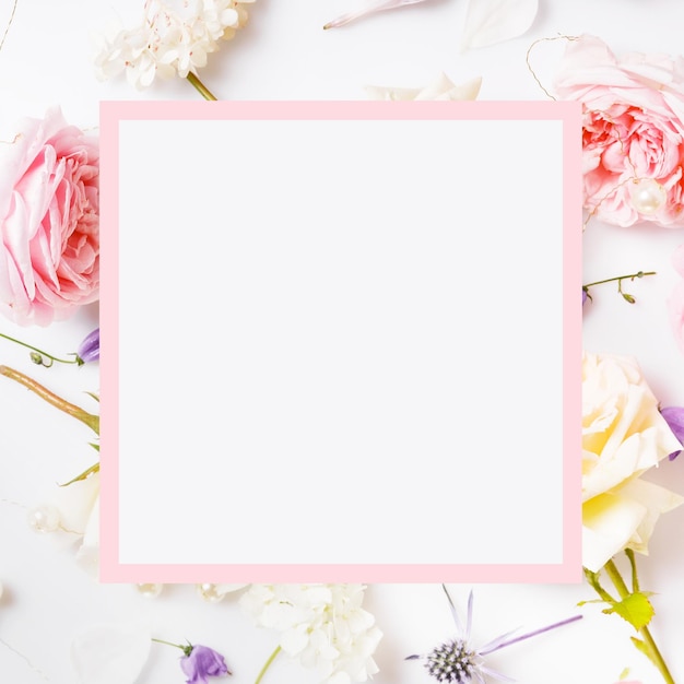 Festive flower composition on the white wooden background Overhead view