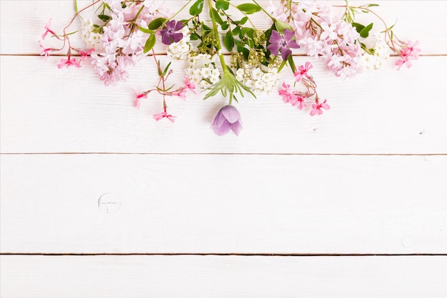 Festive flower composition on the white wooden background Overhead view