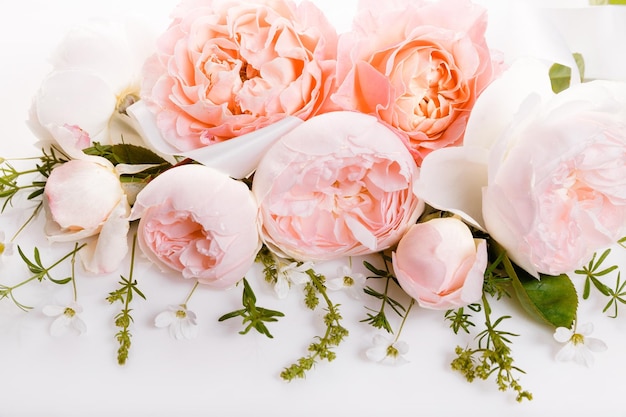 Festive flower composition on the white wooden background Overhead view