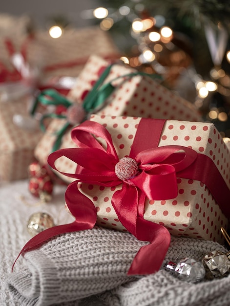 Festive gift boxes under the Christmas tree closeup