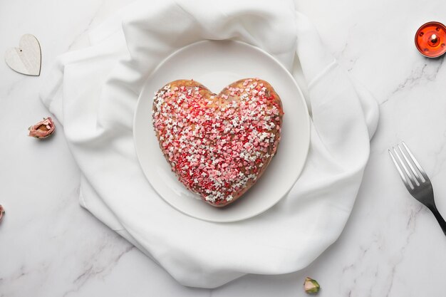 Festive heart shaped cake on plate