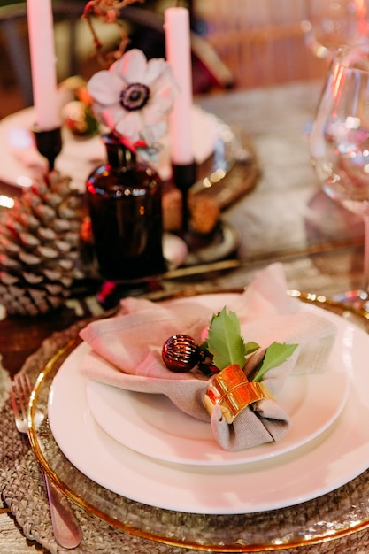 Festive large table decorated with christmas symbols candles sparkle party celebration luxury hall