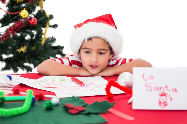 Festive little boy writing wish list