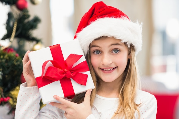 Festive little girl holding a gift