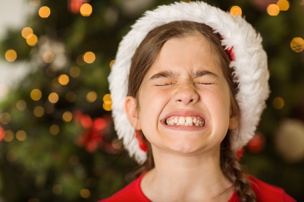 Festive little girl scrunching up her face