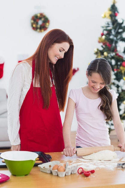 Festive mother and daughter baking together