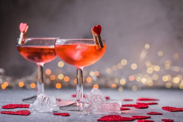 Festive pink cocktail with champagne or prosecco  for St. Valentine's day. Couple of glasses