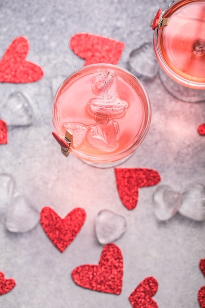 Festive pink cocktail with champagne or prosecco  for St. Valentine's day. Couple of glasses