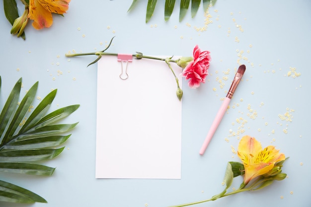 Festive postcard mock up on blue background with alstroemeria and aster flowers