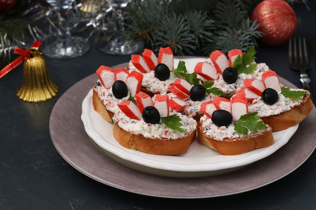 Festive sandwiches with crab sticks, feta cheese and black olives