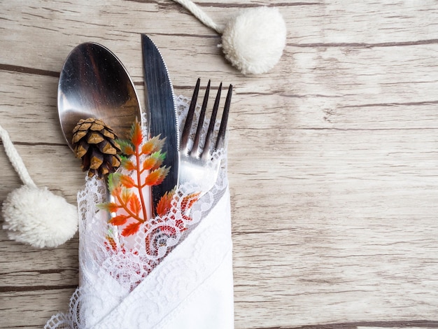 Festive setting for christmas or thansgiving holiday dinner Vintage cutlery on the white napkin on old wooden background with copy space