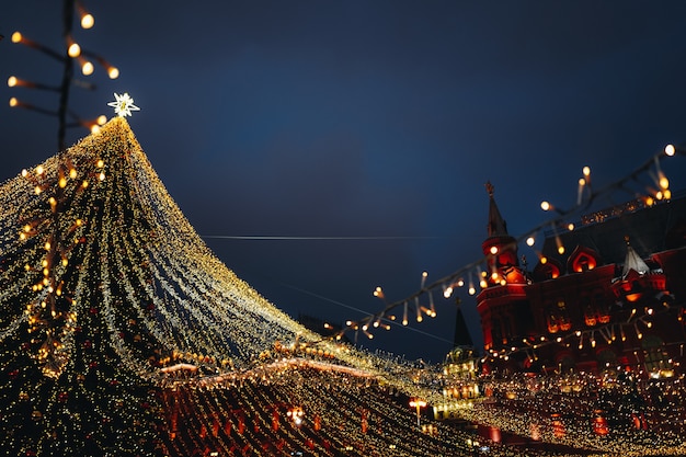 Festive sparkling garlands and gold decorations with Christmas tree as symbol of Happy New Year