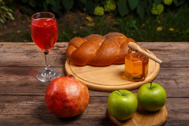 Festive table for Rosh Hashanah pomegranate wine honey apples challah