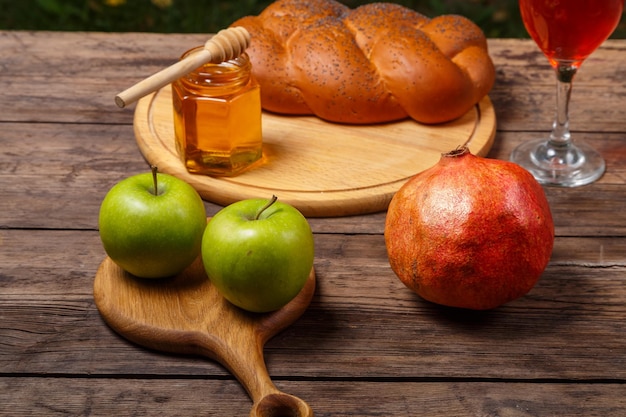 Festive table for Rosh Hashanah pomegranate wine honey apples challah