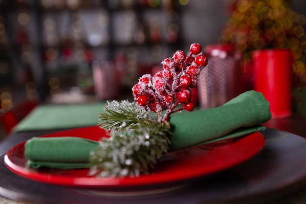 Festive table setting for Christmas eve in red and green colors.