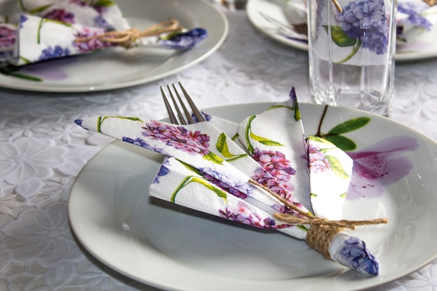 Festive table setting. Plate, glasses, napkins