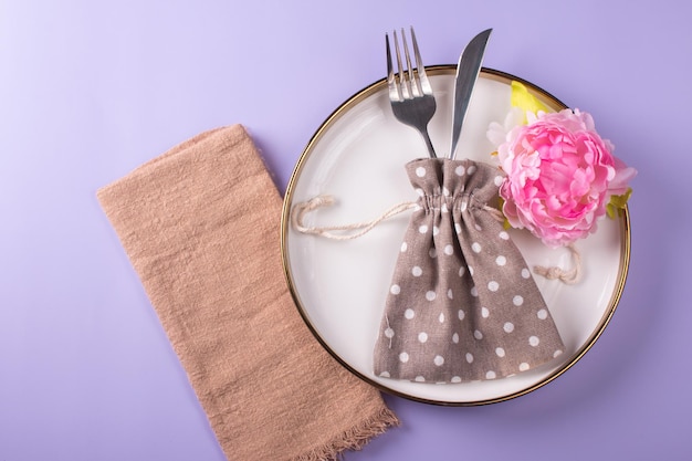 Festive table setting with cutlery Empty ceramic plate with fork knife and napkin