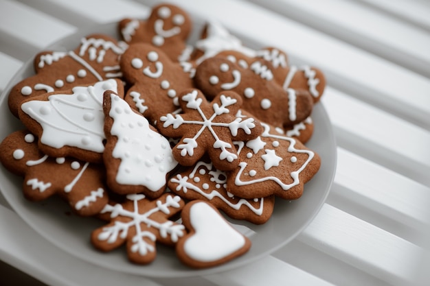 Festively decorated gingerbread cookies on a plate. Winter christmas spirit