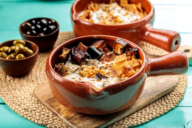 Fettah Eggplant or Fatet Batenjan served in dish isolated on wooden table side view of middle eastern food