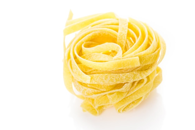 Fettuccine nests pasta on a white background.