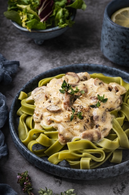 Fettuccine pasta with cream sauce with mushrooms.