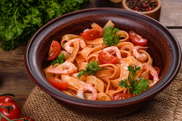 Fettuccine pasta with shrimp, cherry tomatoes, sauce, spices and herbs