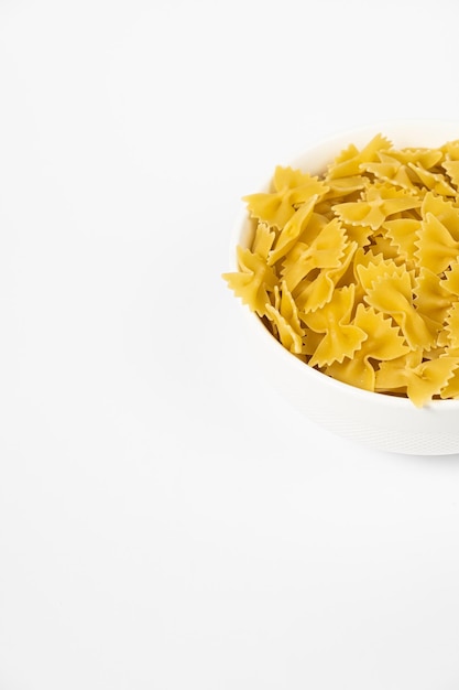 Few Cavatappi Cellentani nest in a plate on white background top view