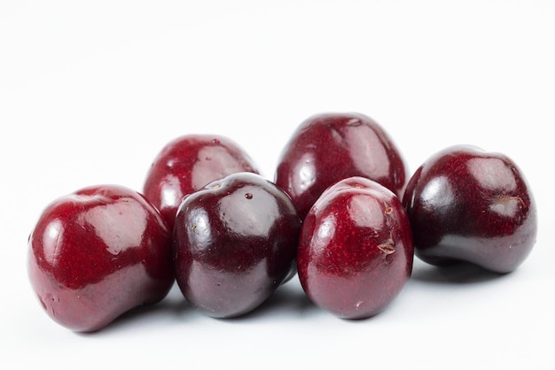 A few delicious cherries on white background.