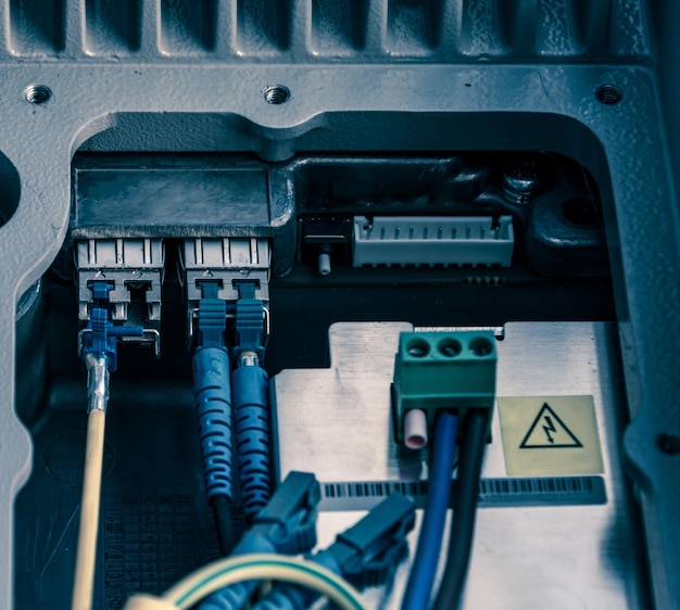 Fiber Optic cables connected to an optic ports and UTP Network cables connected to ethernet ports