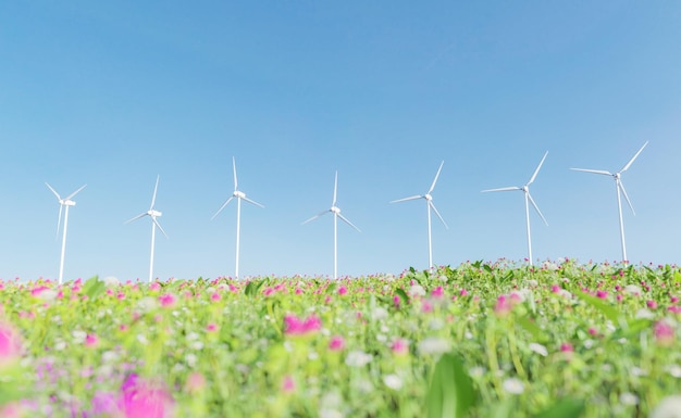 Field full of flowers with wind turbines in the background