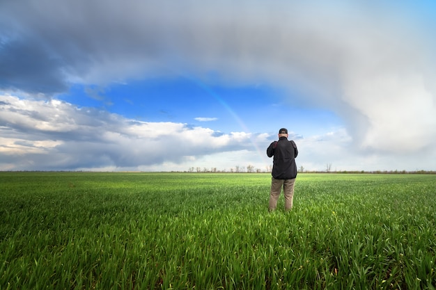 Field of young wheat  man on the field agriculture