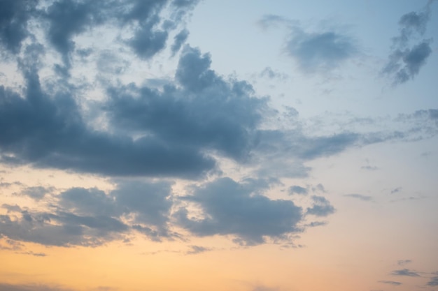 Fiery orange sunset sky and dramatic dark cumulus clouds, evening sky. Beautiful perfect sky for your photos. Heavenly background to overlay